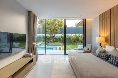 Luxurious bedroom with pool view and modern decor, featuring floor-to-ceiling windows and elegant furnishings.