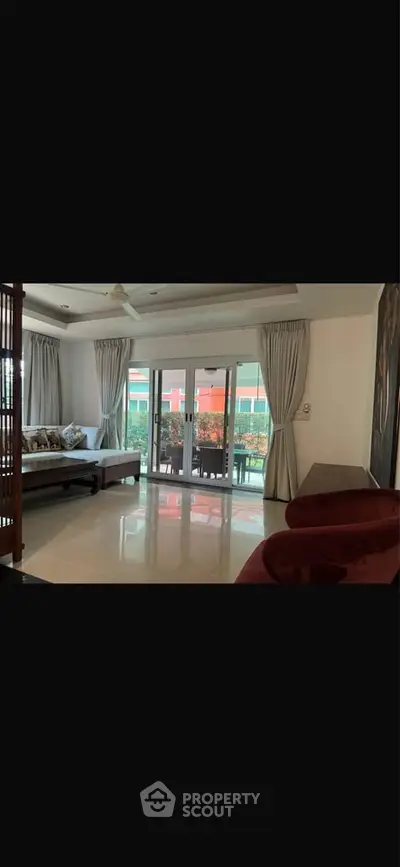 Spacious living room with elegant decor and large windows for natural light