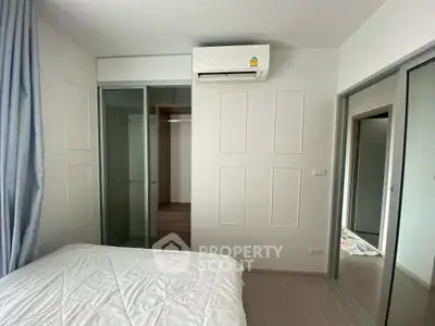 Modern bedroom with air conditioning and sliding closet doors