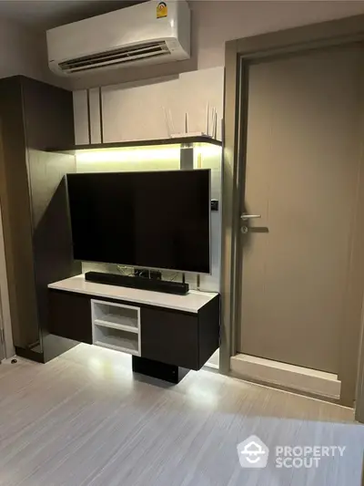 Modern living room with wall-mounted TV and air conditioner