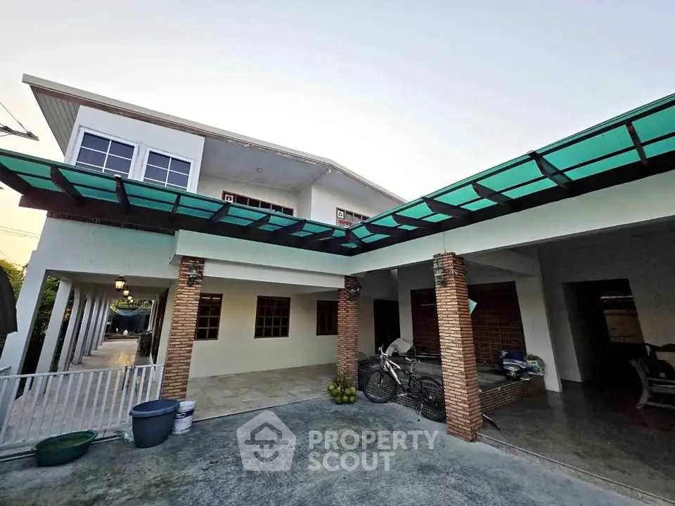 Spacious two-story house with covered patio and modern exterior design.