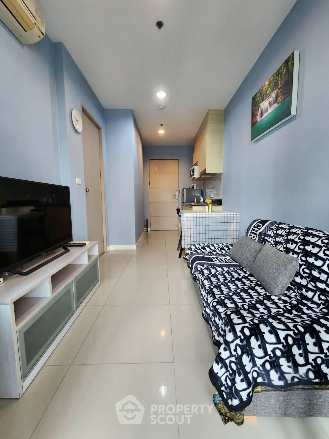 Modern living room with sleek design and cozy ambiance in a stylish apartment.