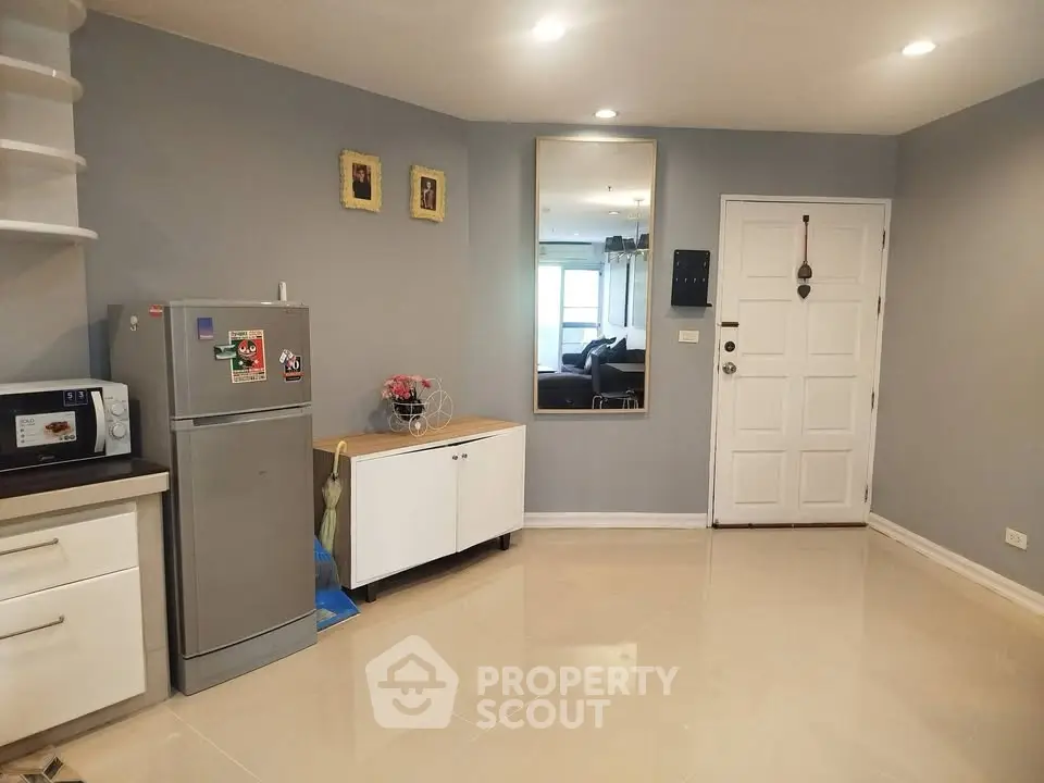 Modern kitchen with sleek appliances and stylish decor in a cozy apartment.