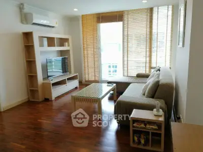 Spacious living room with modern furniture and large windows in a stylish apartment.