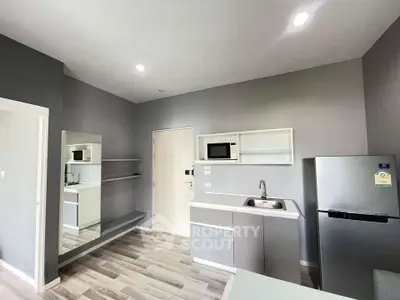 Modern kitchen with sleek cabinetry, stainless steel appliances, and stylish gray accents.