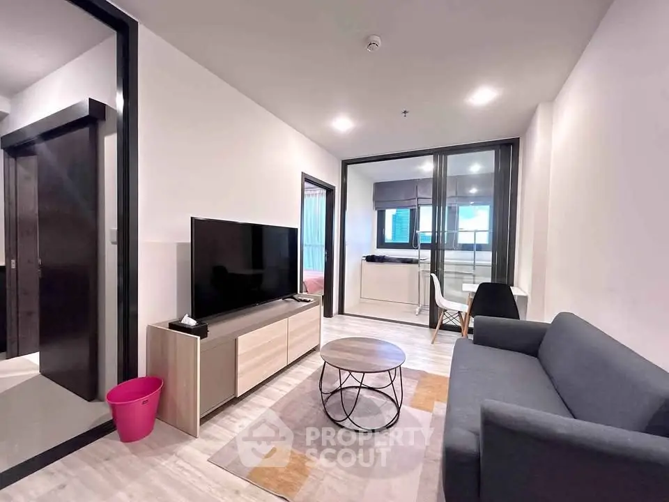 Modern living room with sleek furniture and open layout in a stylish apartment.