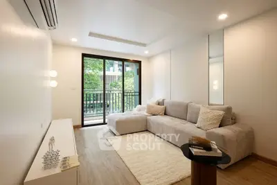 Modern living room with cozy sofa and balcony view in a stylish apartment.
