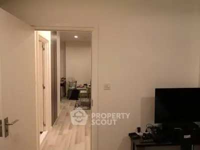 Modern interior with open layout, featuring a cozy living area and sleek flooring.