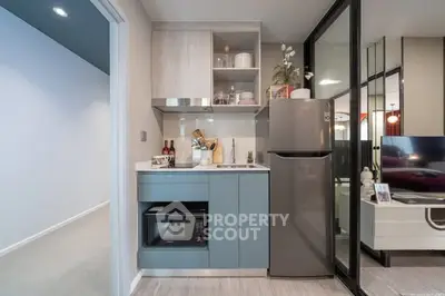 Modern compact kitchen with sleek appliances and stylish cabinetry