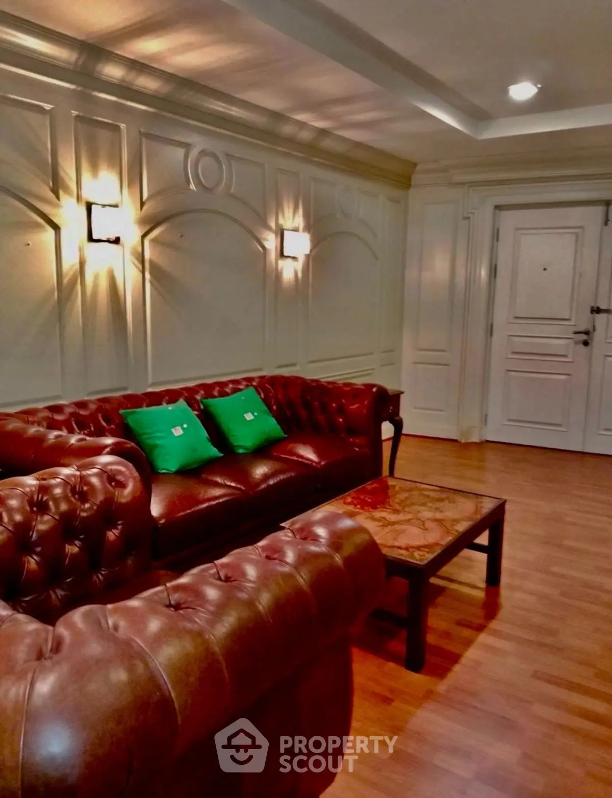 Luxurious living room with elegant leather sofas and stylish wall paneling.