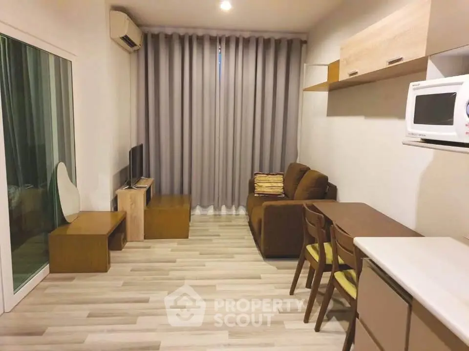 Cozy living room with modern furniture and natural light, perfect for relaxation and entertainment.