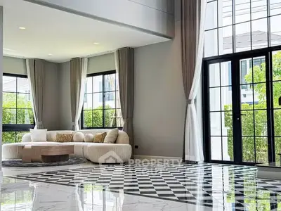 Luxurious living room with elegant decor and large windows offering abundant natural light.