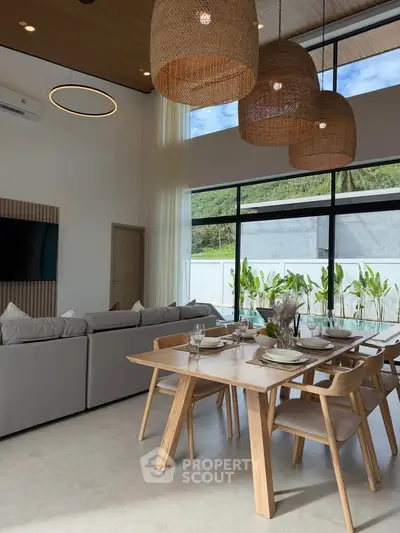 Stunning modern living room with high ceilings, large windows, and elegant dining area, perfect for entertaining.