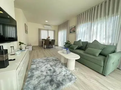 Spacious living room with modern decor and large windows for natural light.