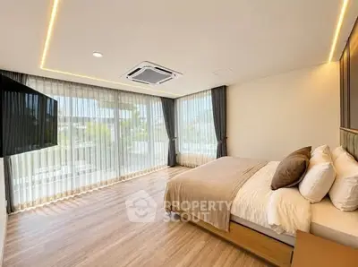 Luxurious bedroom with floor-to-ceiling windows and modern decor