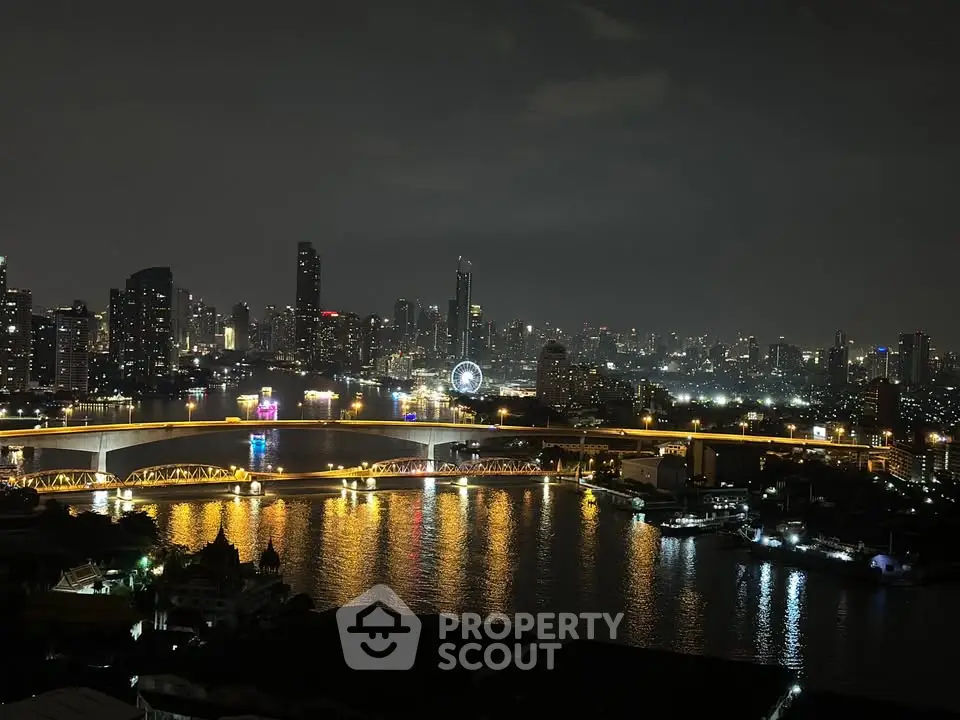 Stunning nighttime cityscape view with illuminated skyline and river reflections.