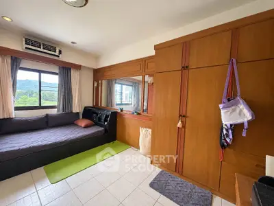 Cozy bedroom with mountain view, featuring a daybed and wooden wardrobe.