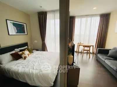 Modern apartment with cozy bedroom and stylish living area, featuring large windows and elegant decor.