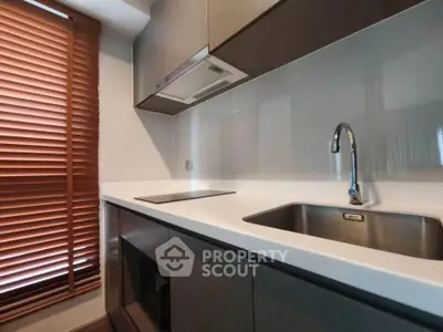 Modern kitchen with sleek cabinetry and stainless steel sink