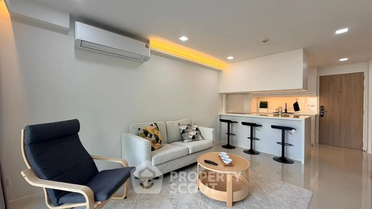 Modern living room with sleek furniture and open kitchen layout