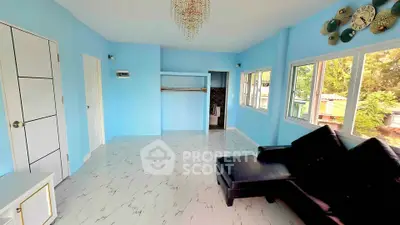 Spacious living room with modern decor and large windows offering natural light.