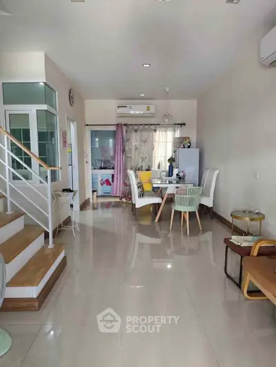 Spacious open-plan living and dining area with modern decor and natural light.