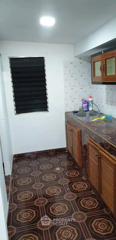 Charming kitchen with closed layout and wooden cabinets, perfect for cozy cooking experiences.