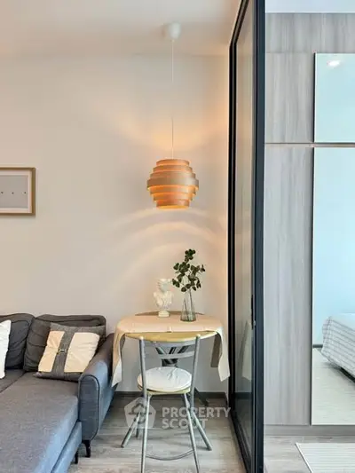 Modern living room with stylish pendant light and cozy seating area.