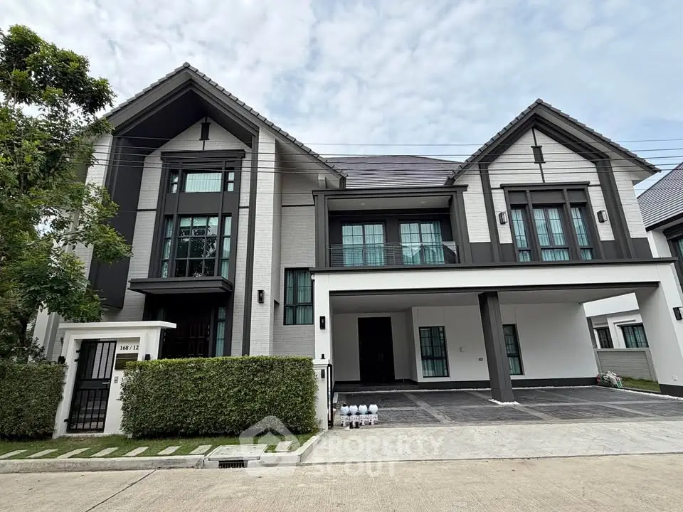 Stunning modern two-story house with spacious driveway and lush greenery, perfect for luxurious family living.