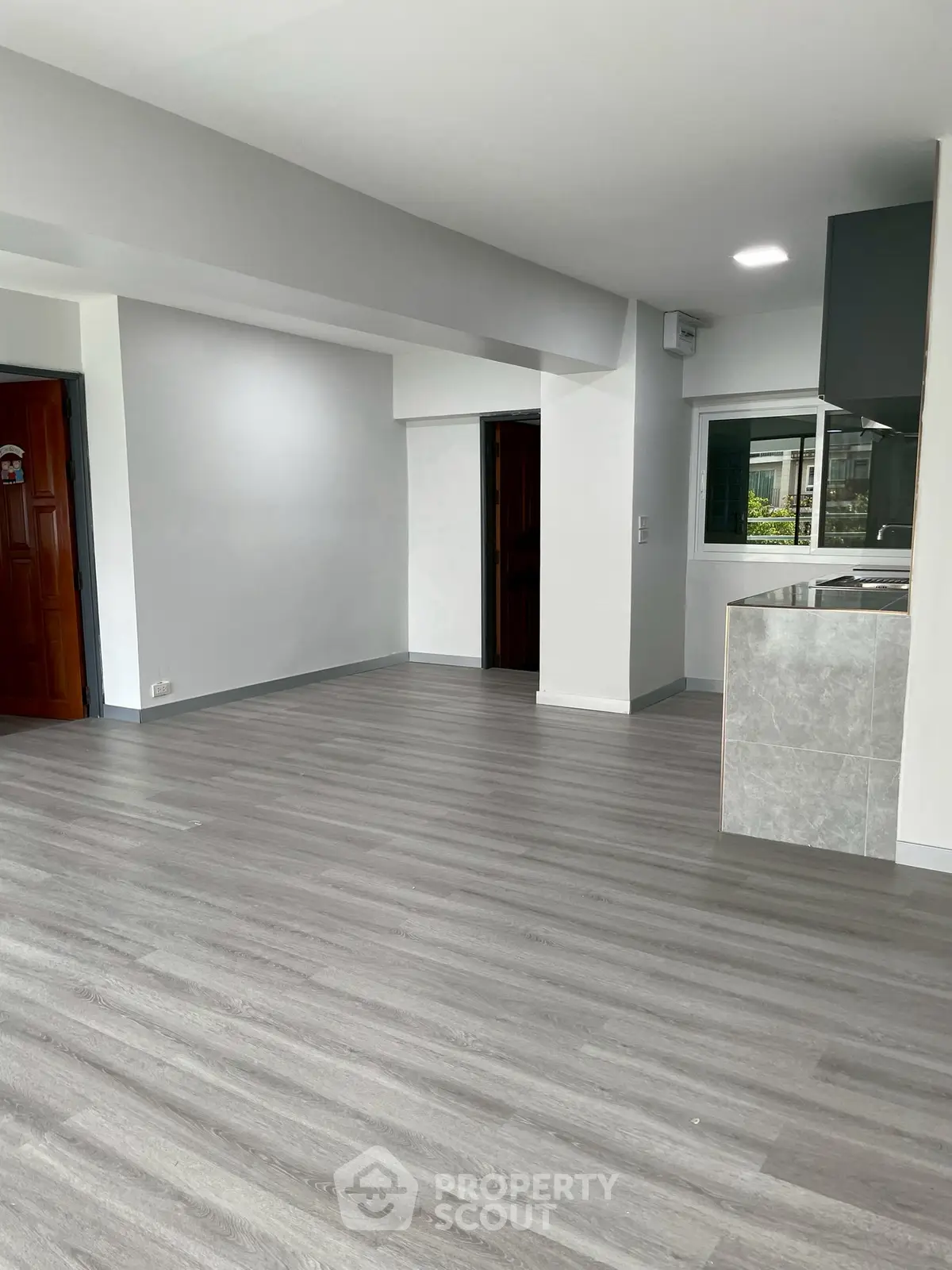 Spacious modern living room with open layout and sleek flooring