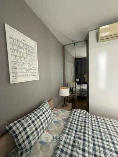 Cozy bedroom with stylish decor and mirrored wardrobe