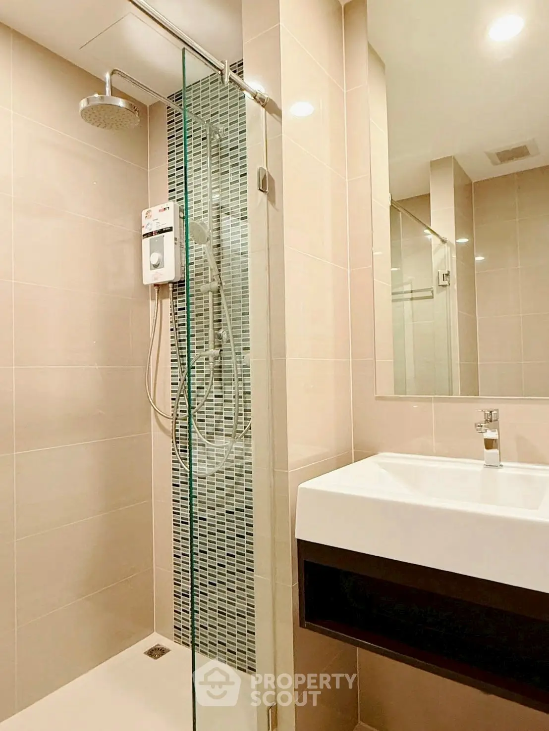 Modern bathroom with sleek shower and stylish sink in contemporary apartment.