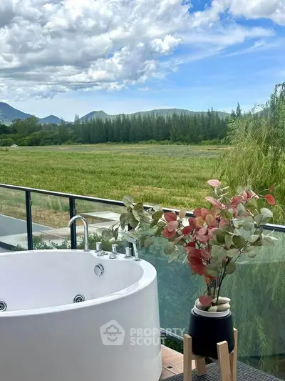 Luxurious balcony with outdoor bathtub and stunning mountain view