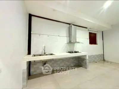 Spacious kitchen with modern gas stove and sleek design