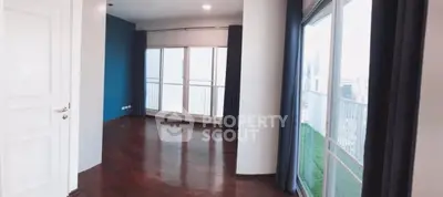 Spacious corner unit with floor-to-ceiling windows and elegant hardwood floors.