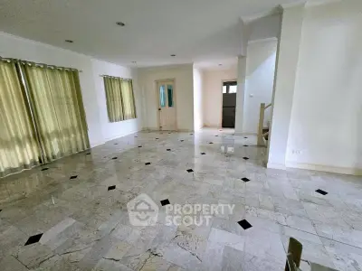 Spacious living room with elegant marble flooring and natural light