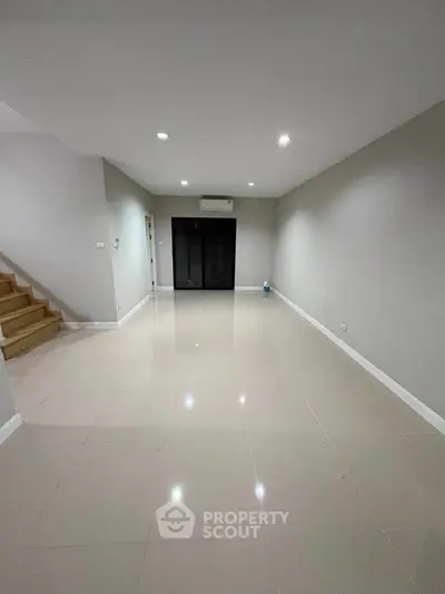 Spacious modern living room with sleek tile flooring and minimalist design