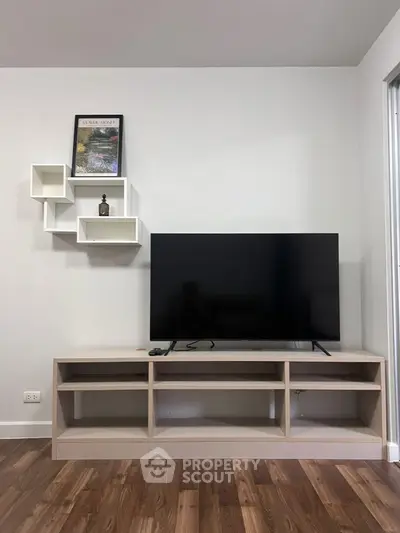 Modern living room with sleek TV stand and wall-mounted shelves