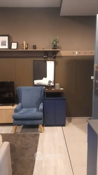 Modern living room with stylish blue armchair and sleek decor