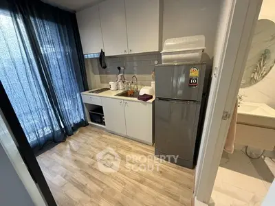 Modern compact kitchen with sleek appliances and stylish flooring