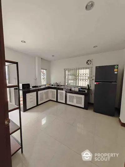 Modern kitchen with sleek black and white cabinetry and spacious layout