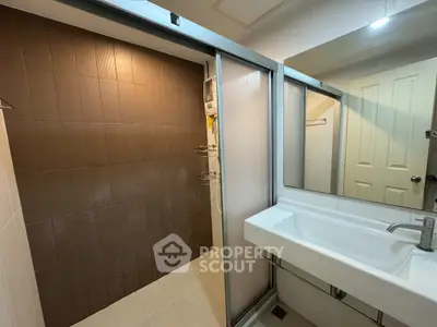 Modern bathroom with sleek sink and spacious shower area
