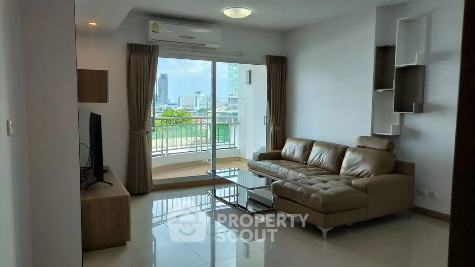 Modern living room with leather sofa and city view balcony in high-rise apartment