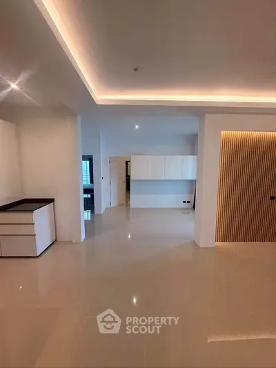 Spacious modern living area with sleek design and ambient lighting