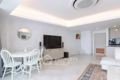Spacious modern living room with elegant dining area and sleek kitchen in open layout.