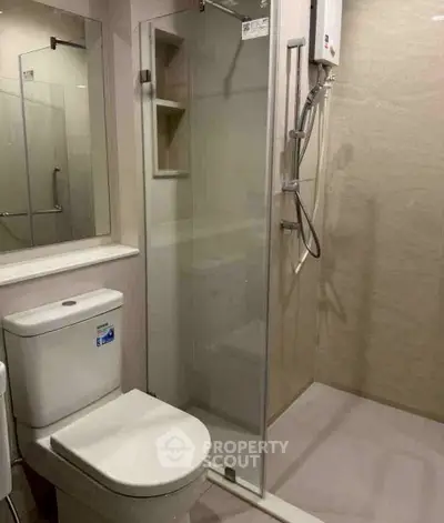 Modern bathroom with glass shower and sleek fixtures in a contemporary apartment.