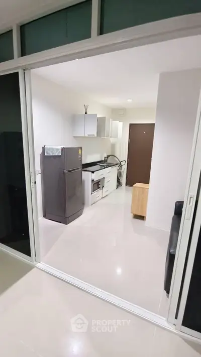 Modern kitchen with sleek appliances and open layout in a stylish apartment.