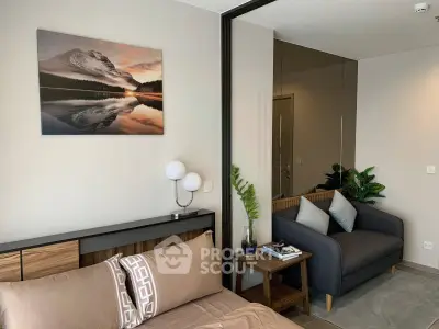 Modern bedroom with cozy seating area and stylish decor