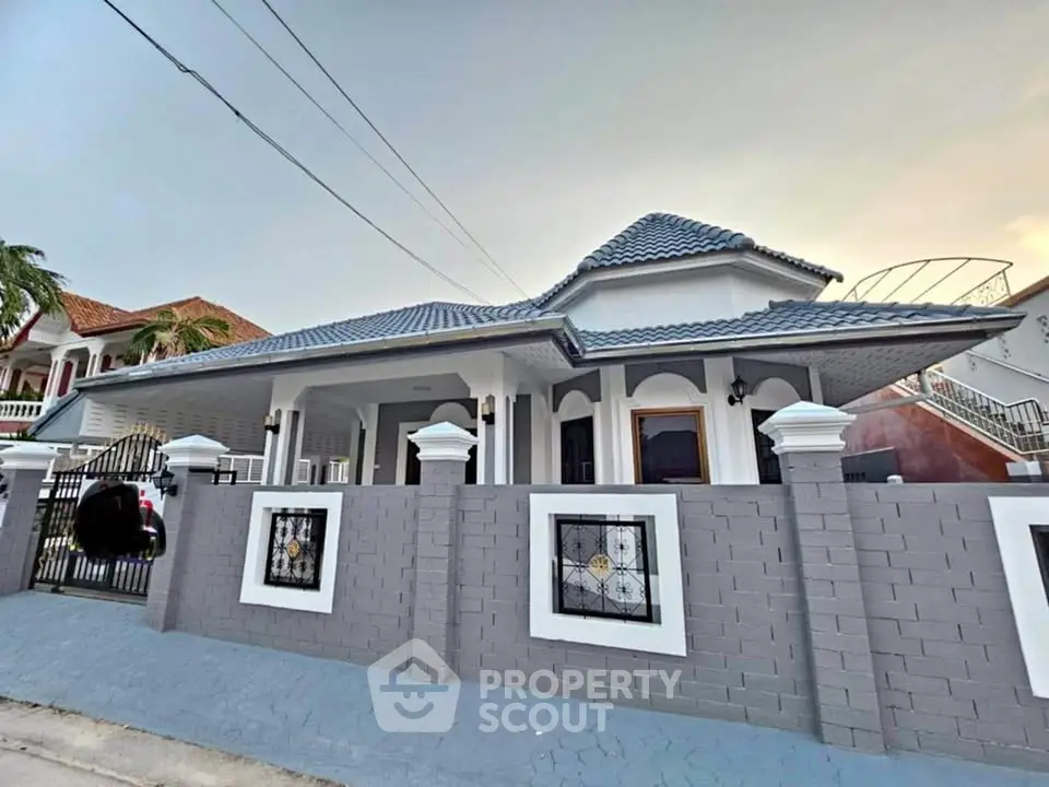 Stunning modern house with elegant roof design and spacious front yard.