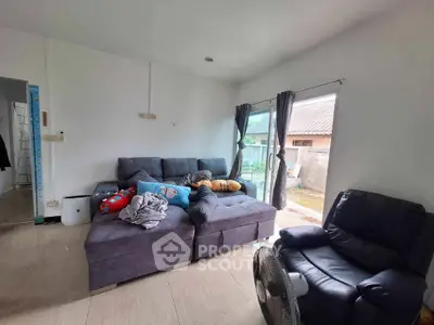 Cozy living room with plush sofa and large window offering natural light